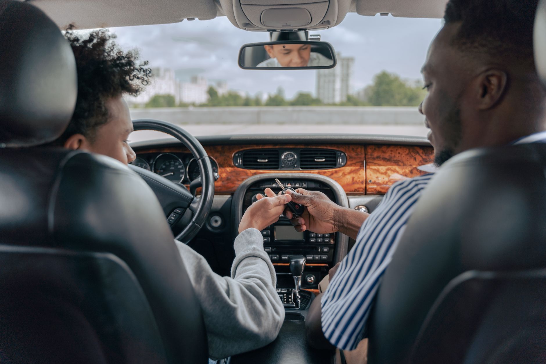 An instructor sitting calmly beside a learner driver during a lesson