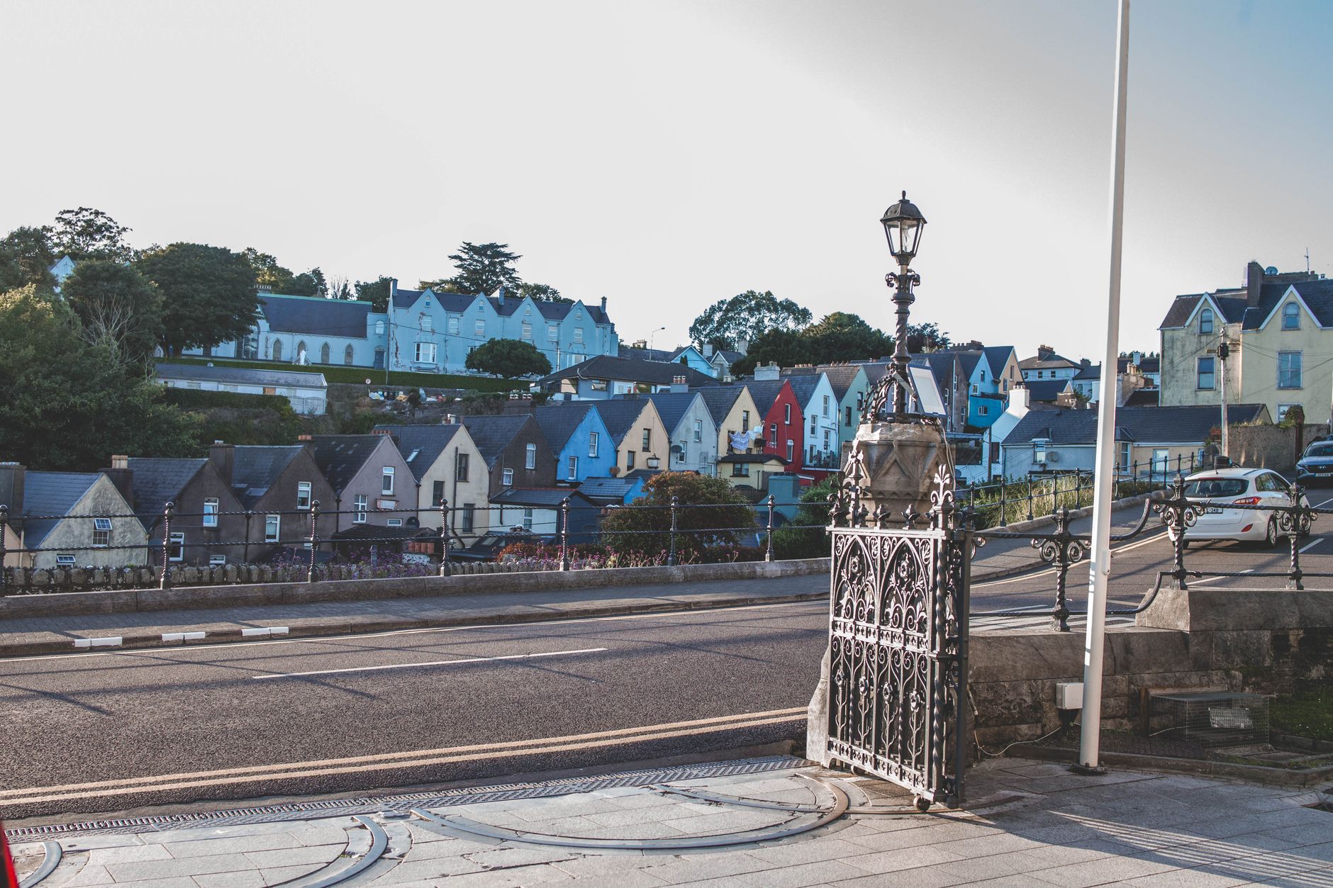 A quiet Irish coastal town street lined with terraced houses