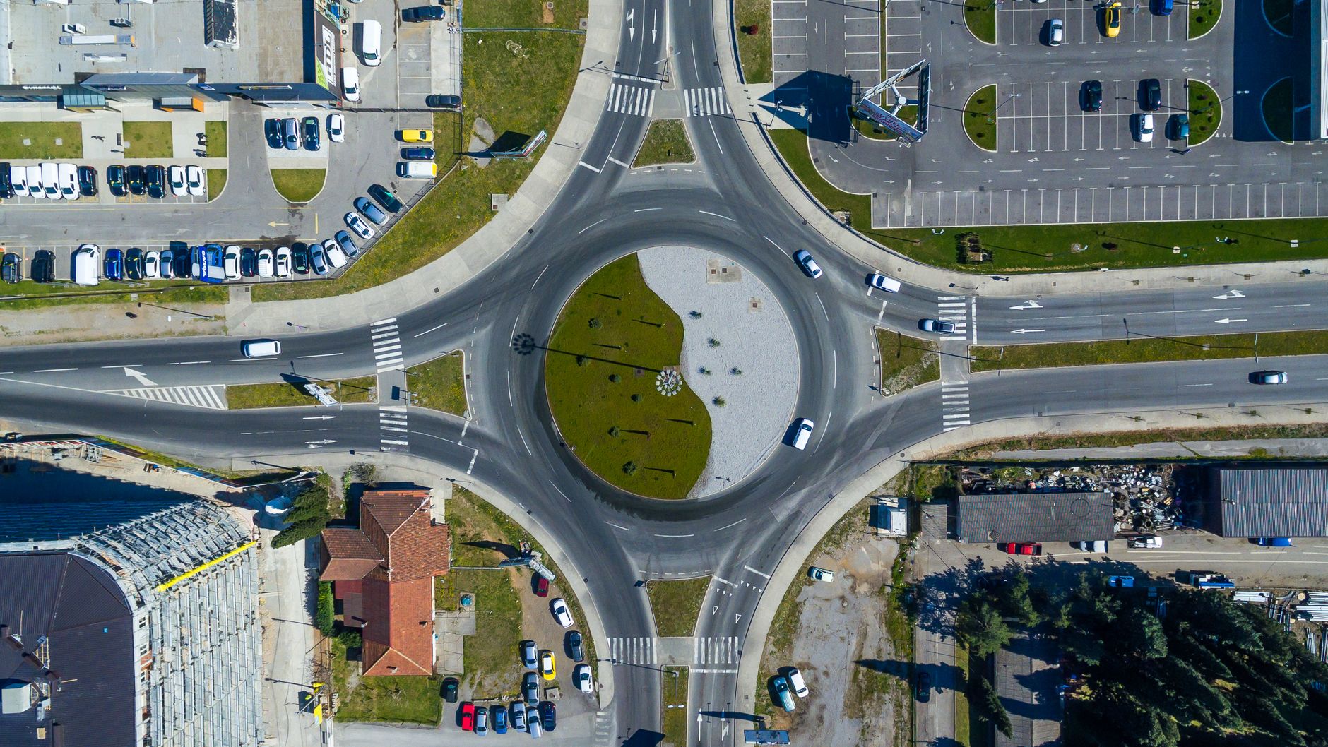 A roundabout seen from above with several roads feeding into it